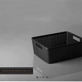 BINO woven plastic basket medium black under the sink setup for compact storage.