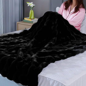 BlanketSolution fluffy furry black throw couch setup with warm ambiance