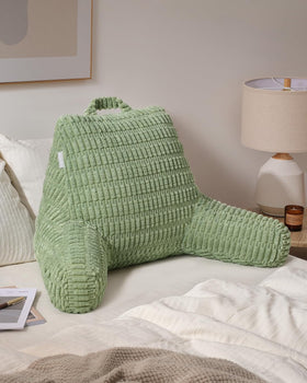 Blissful Diary pillow on couch illustrates ideal sit-up posture while watching TV