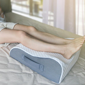 BlissfulNest leg elevating pillow on bed for comfortable leg elevation after surgery