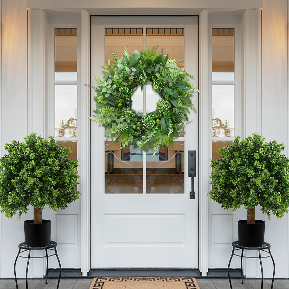 Bloeien artisans handcrafted this greenery wreath for lasting beauty.