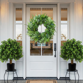 Bloeien artisans handcrafted this greenery wreath for lasting beauty.