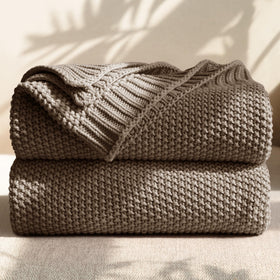 blunique 100% cotton cable knit throw on sofa for cozy warmth.
