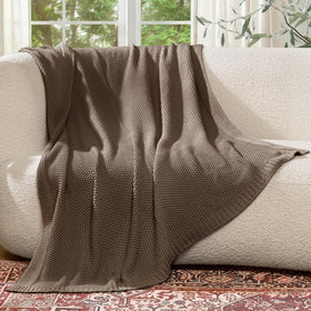 blunique knit throw draped on chair demonstrates light, breathable warmth.