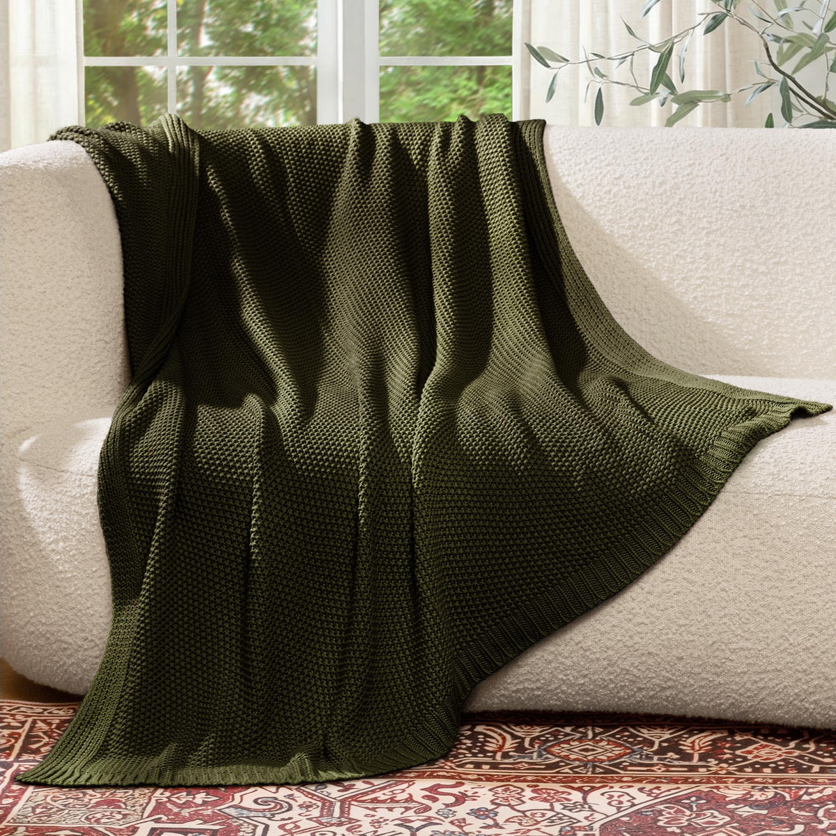 blunique Olive Green throw on chair adds decorative warmth.