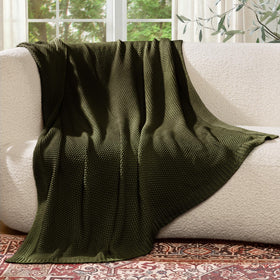 blunique Olive Green throw on chair adds decorative warmth.