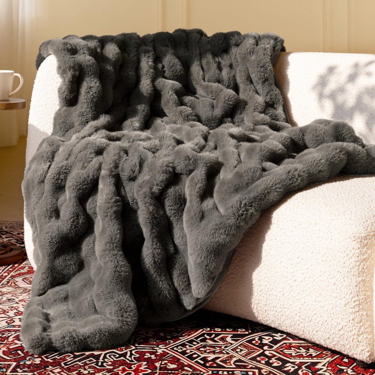 Blunique Ultra Soft Cozy Faux Fur Throw Blanket on a couch for warm evenings