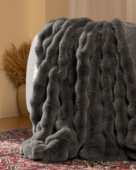 Close-up of faux rabbit fur side from Blunique blanket highlighting luxurious softness