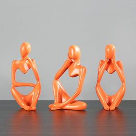 BMLCGJ gold thinker sculpture on mantel elevates office shelf styling.
