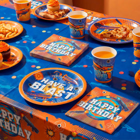 BOIUNPARTY Dart War tablecloth creates a bold centerpiece for snacks.