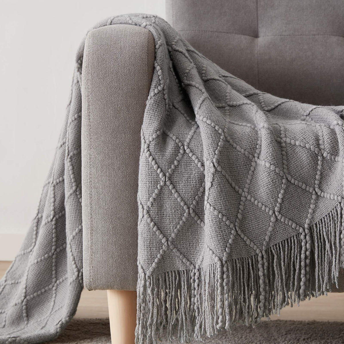 bourina blanket features rolled fringed edges for a refined finish