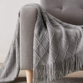 bourina blanket features rolled fringed edges for a refined finish