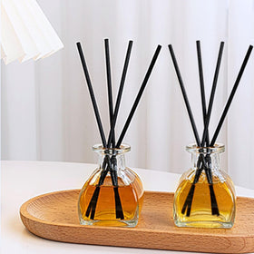 Brajttt vintage glass vases with patterned surface catch light.
