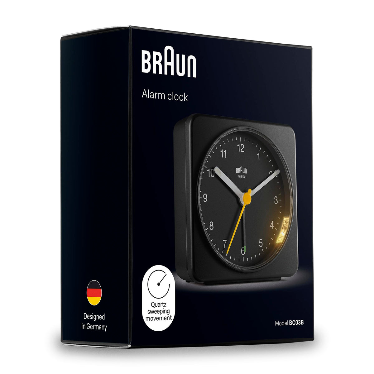 Braun clock in black finish complements modern bedroom decor.