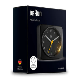Braun clock in black finish complements modern bedroom decor.