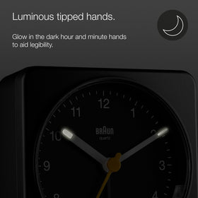 Braun clock with luminous hands helps reading time in the dark.