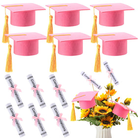 Breling pink graduation cap with gold tassel as table centerpiece