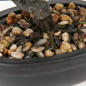 Briful artificial bonsai on table-top frames a modern space.