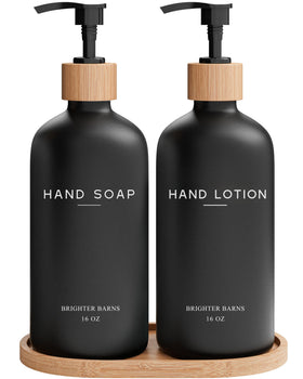 Brighter Barns black glass soap dispenser set on a sleek countertop for modern bathrooms.