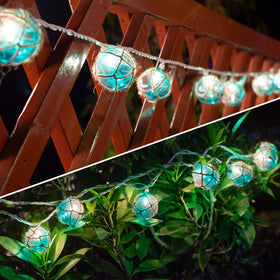 Brillarlights nautical string lights with blue G50 bulbs brighten a beach-themed room.