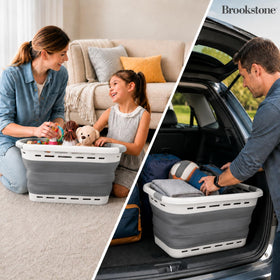 Brookstone 11 Gallon XL collapsible basket in a small apartment, ideal for compact spaces.