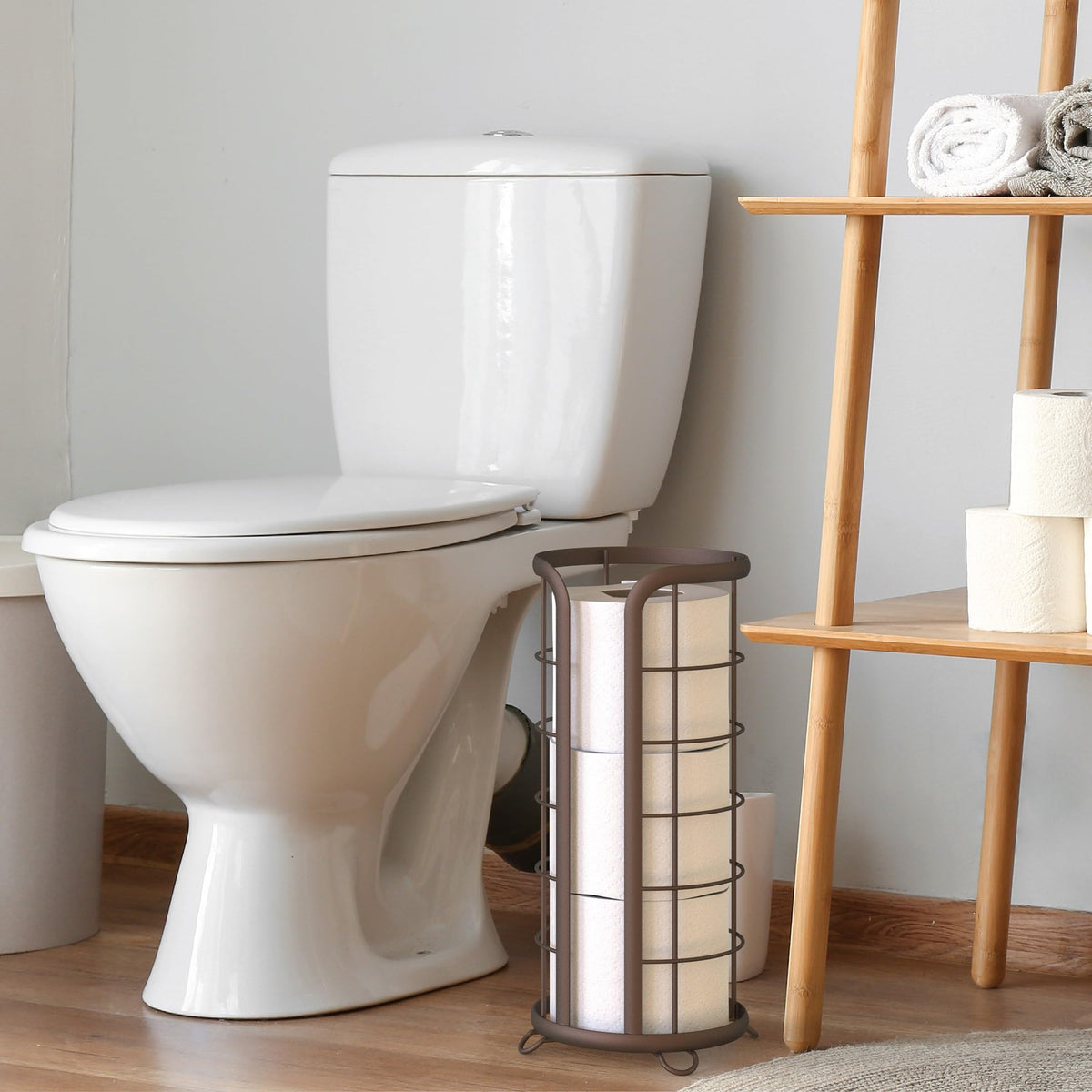 Brookstone bronze toilet paper stand mega-roll capacity keeps spare rolls within reach.