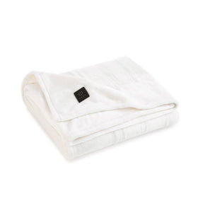 Brookstone heated plush throw close-up of soft fabric for warm comfort.