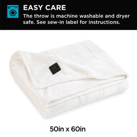 Brookstone plush throw draped on sofa ready for cozy evenings.