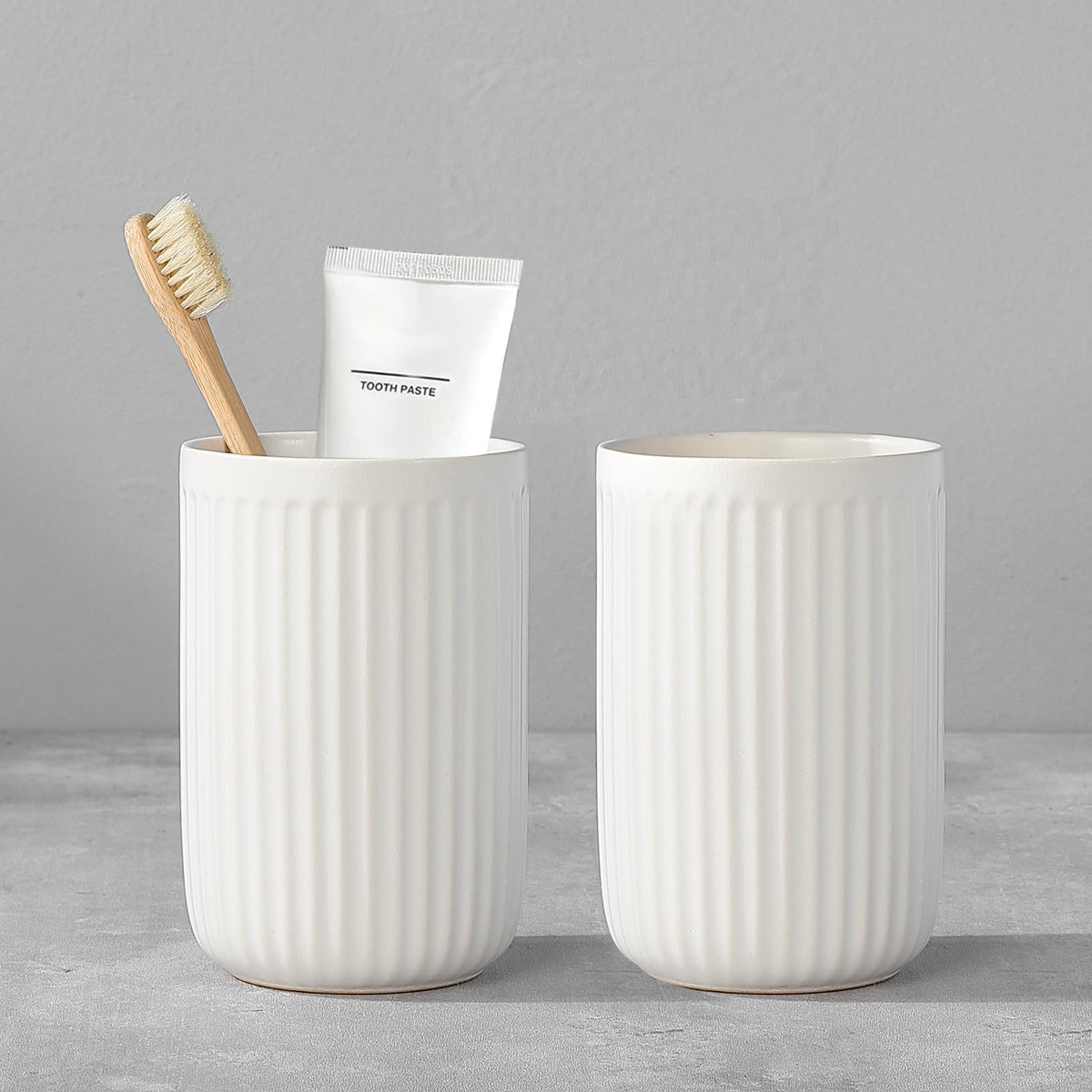 BSDISP white ceramic toothbrush holders with two cups for organized bathroom counter space.
