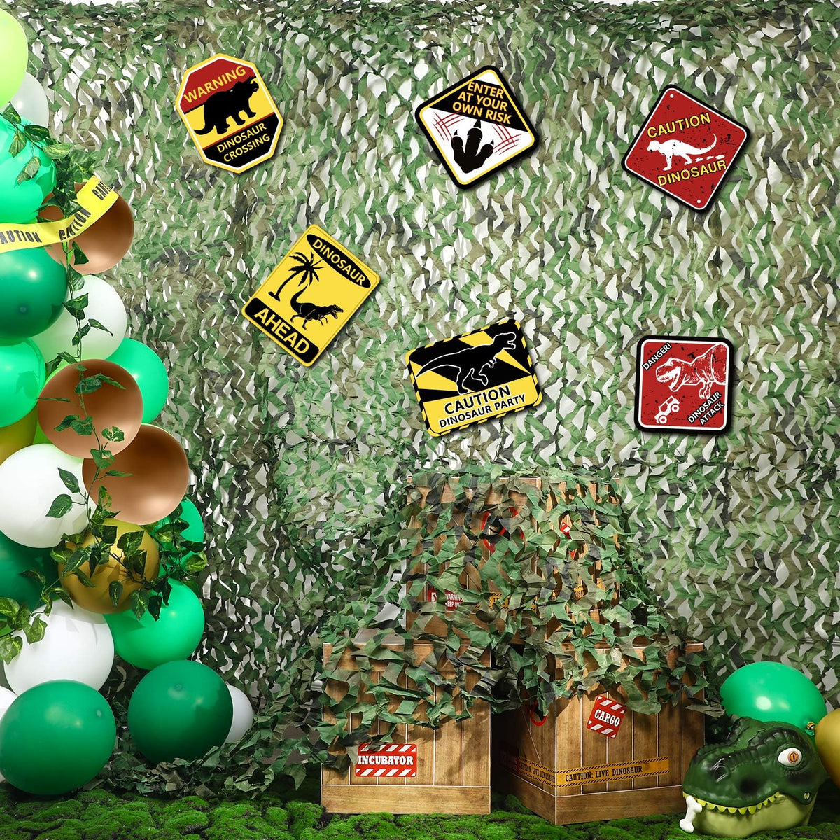 Bucherry dinosaur netting creates an immersive wall backdrop for party photos.