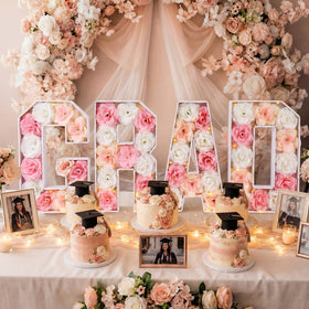 Bucherry pink grad centerpiece with forty artificial roses enhances photo backdrops.