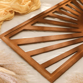 Burbell Sun wall art in dark brown adds cozy bedroom charm.