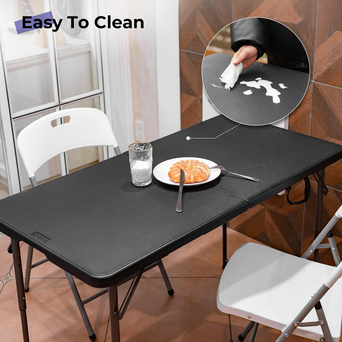 Byliable folding table folded for compact storage with carrying handle