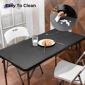 Byliable folding table folded for compact storage with carrying handle