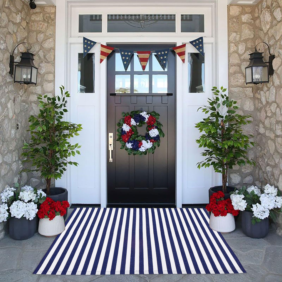 CAINANEL blue and white striped rug on the front porch adds festive curb appeal