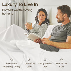 Sheets drape smoothly over a bed, highlighting a refined, silky finish