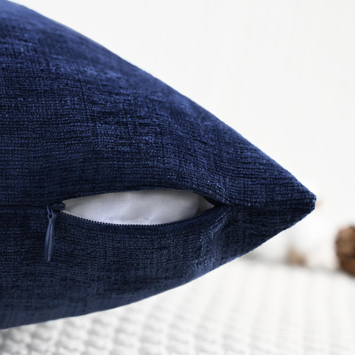 CaliTime navy-blue pillow cover on chair instantly elevates seating ambiance.