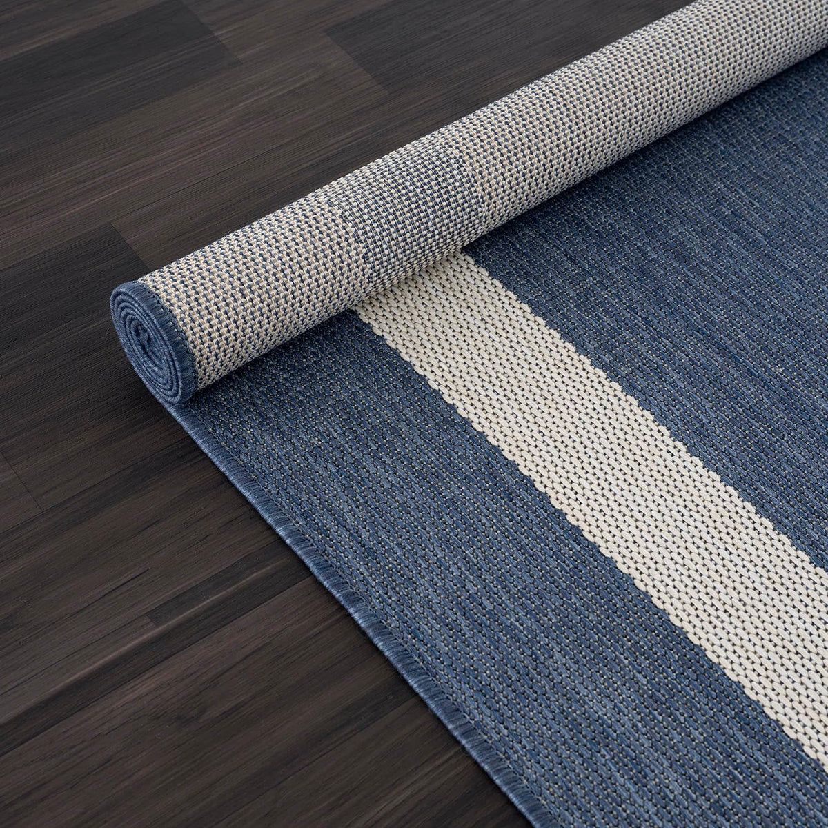 Outdoor cleaning: CAMILSON rug being washed with a hose.