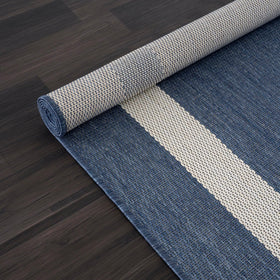 Outdoor cleaning: CAMILSON rug being washed with a hose.