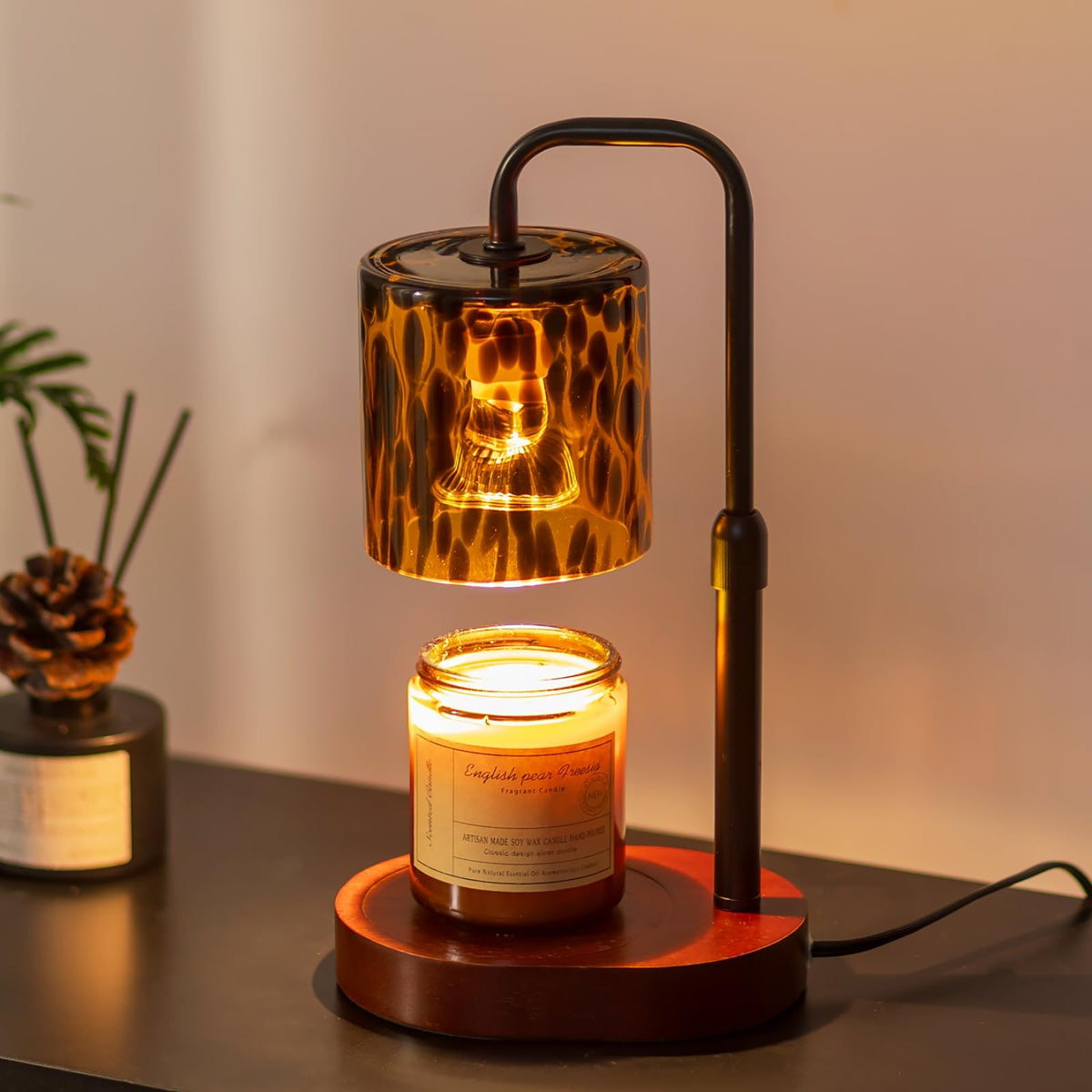 Candeldo tortoise-shell lamp front view adds warm ambient lighting to living room.