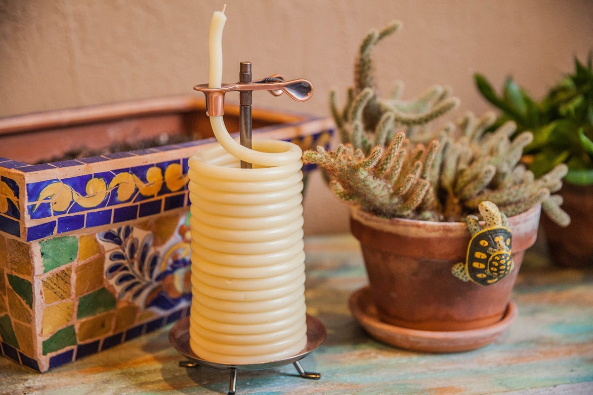 Candle by the Hour 80-hour vertical candle on stand lit for warm ambiance