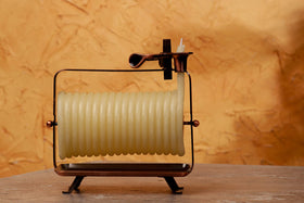 Candle by the Hour table centerpiece featuring copper stand for elegant ambiance