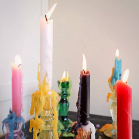 Candlestock Wax-drip demonstration on a bottle for visual drama.