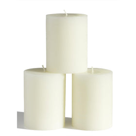CandWAX 3x4 inch ivory pillar candle set on a plate for elegant decor.