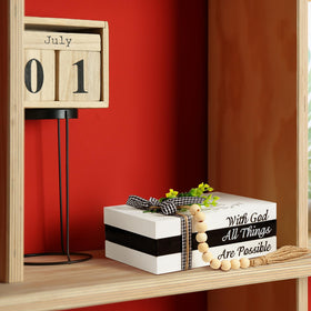 Capoda decorative books arranged on mantle create a cozy focal point.