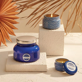 Capri Blue Havana Vanilla cobalt glass jar glowing in dim lighting for cozy ambiance