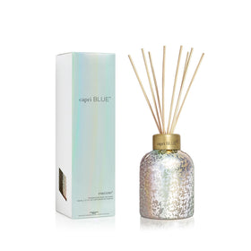 Capri Blue Volcano reed diffuser bottle with iridescent glass adds stylish ambience.