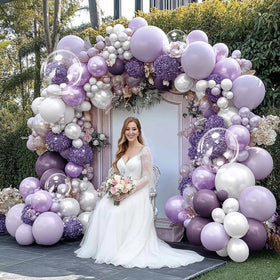 Captank clear bobo balloons sparkle within the arch for a playful vibe