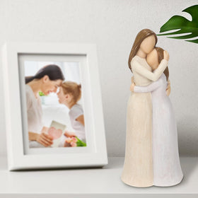 Carracci sculpted mom and daughter; graceful decor for mantels and shelves.