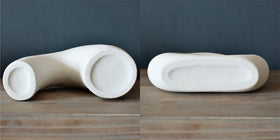 Carrot's Den donut vase white ceramic with hollow design suited for modern entryways.